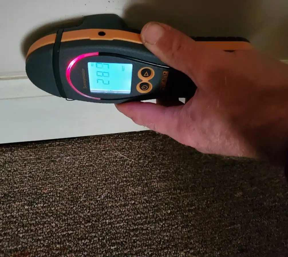 Moisture detection at baseboard during Storm Damage Restoration in Orem